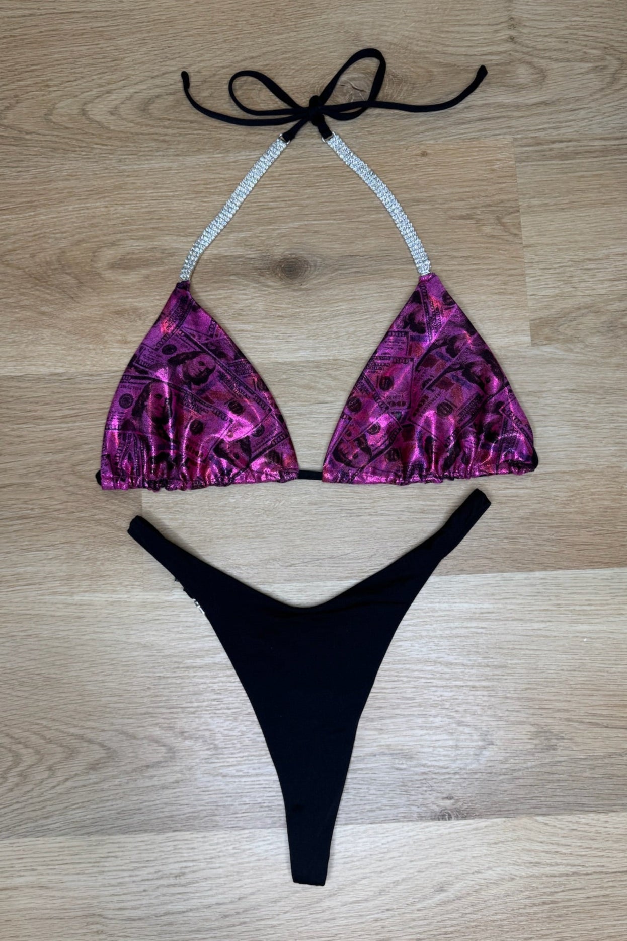 Purple and black bikini set on a wooden surface